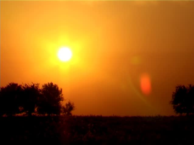 It's a timelapse shot of the sunset in the middle of a very hot summer .
