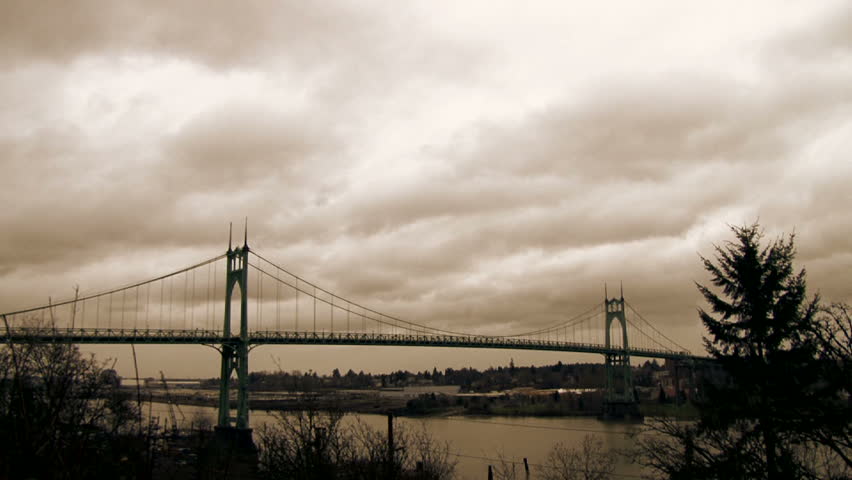 Storm clouds moving fast with traffic driving over the St. John's Bridge in