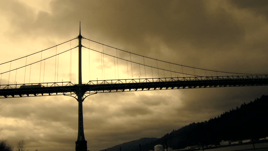Storm clouds moving over the St. John's Bridge with traffic driving over in