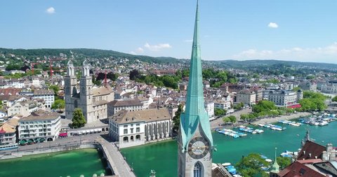 Flying over Zurich and the River Limmat on this beautiful summer day. You can see the famous churches, tourist boats and the city life.