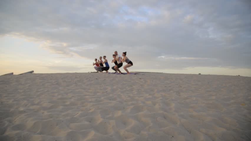 Mixed race group of people exercising yoga healthy lifestyle fitness warrior poses. Concentration.