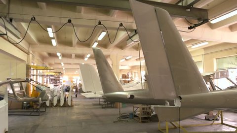 Inside aircraft workshop. Tails of airplanes. Aviation industry development.