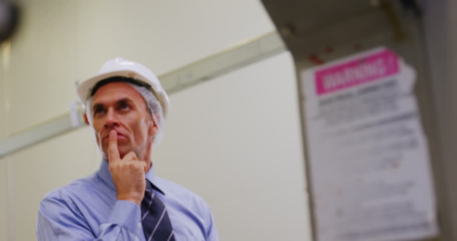 Manager using digital tablet in meat shop