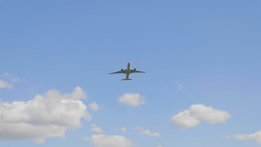 Commercial passenger airplane flying overhead on sunny day. UltraHD stock footage. Royalty-Free Stock Footage #28383940