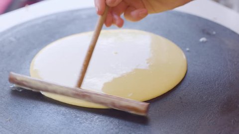 Street cook baking a pancake