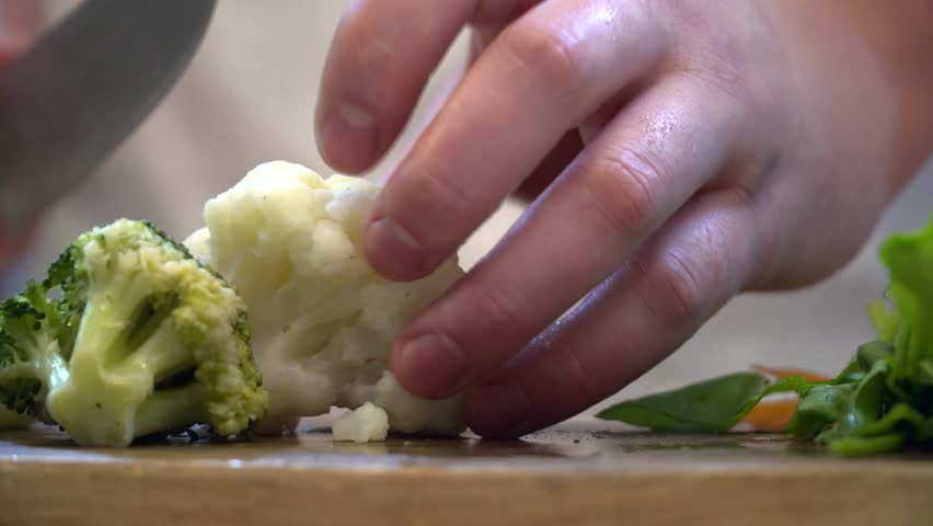 Clsoeup of chef cutting cauliflower Royalty-Free Stock Footage #28385137