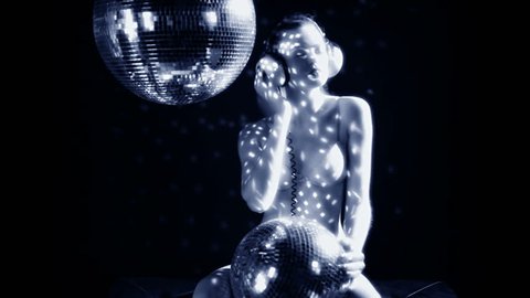 a sexy gogo dancer shot in a studio dancing and posing with a spinning discoball