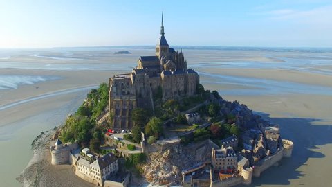 Aerial view of Mont Saint Michel, iconic island and monastery at twilight, Normandy, France, 4k UHD 