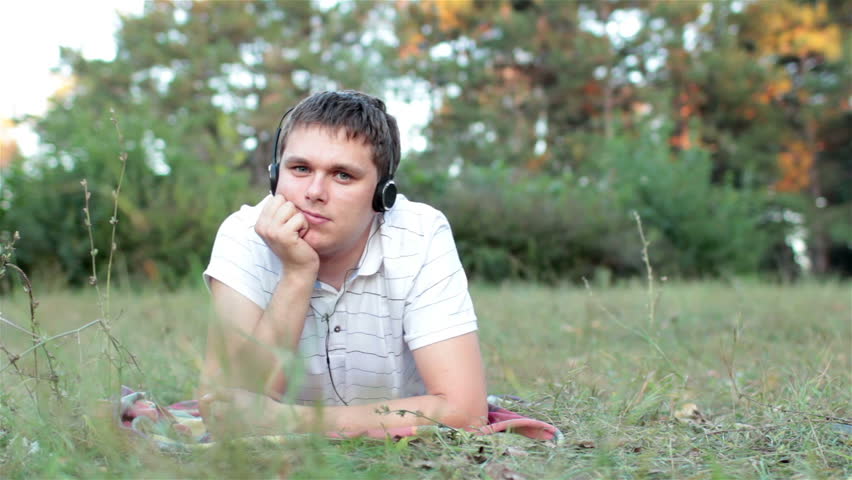 guy listening to music in the park