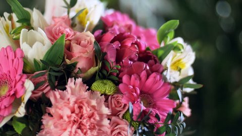 close-up, Flower bouquet in the rays of light, rotation, the floral composition consists of gerbera, Tulip piano, Santini , Alstroemeria, Rose odily, Orchid vanda, eucalyptus