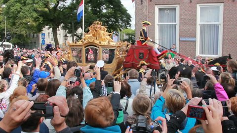 THE HAGUE, HOLLAND - SEPTEMBER 19: Golden Coach with Queen Beatrix of Holland rides on Prinsjesdag on September 19, 2012 in The Hague, Holland. Prinsjesdag is opening of Parliamentary year in Holland