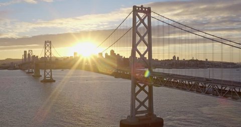Aerial of Sun Shining through San Francisco Bay Bridge, Golden Hour