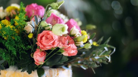 close-up, Flower bouquet in the rays of light, rotation, composition consists of Rose david austin, Rose cream grace, Rose barbados, Eustoma, Santini , Ornithogalum, eucalyptus,