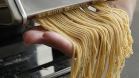 Pasta machine and Italian spaghetti 4K 2160p 30fps UltraHD footage - Dough made  cylindrical solid pasta food 3840X2160 UHD video