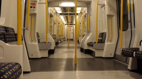 Empty city subway underground tube train carriage swinging sideways and arriving at a station