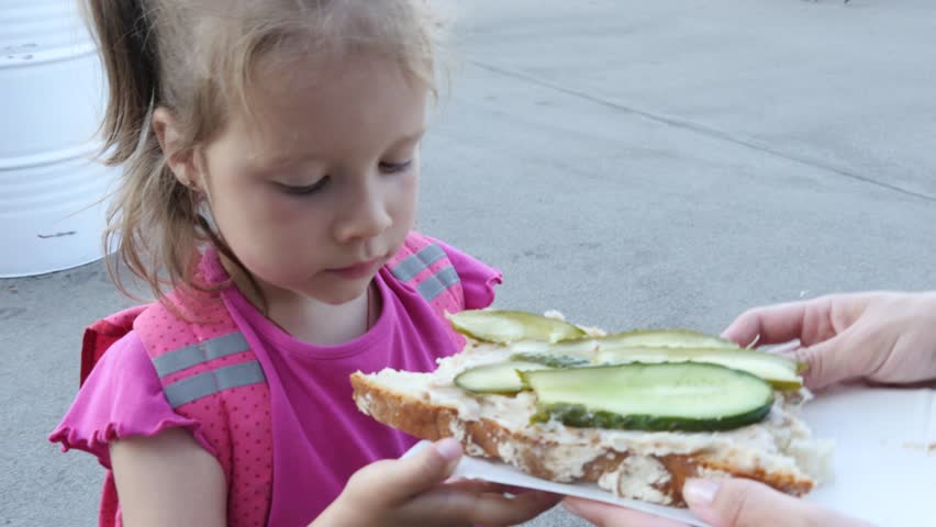 Cute Little Child Daughter Eating Biting And Chewing A Huge Sandwich Outdoors Family Diet