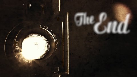 Animation of a retro vintage old fashioned The End title, silent film ariston style, slowly appearing, over the light beam of a Super 8mm projector lens. Antique ghosts, past. Diegetic audio.
