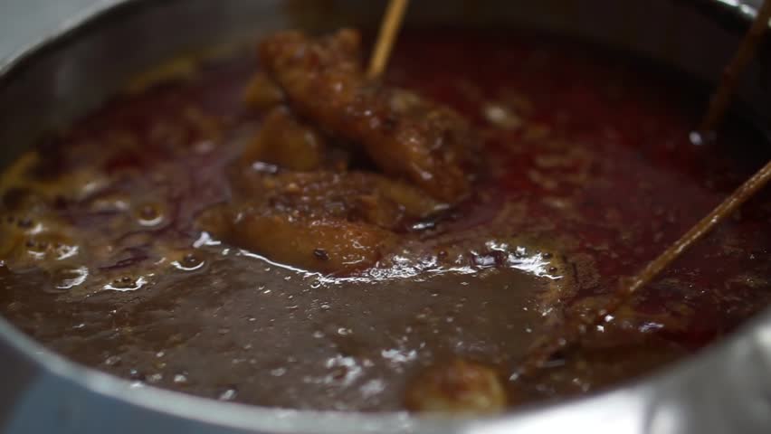 Satay Celup or Malaysia foods, hand pick varieties foods stick on table at local restaurant Royalty-Free Stock Footage #28430191