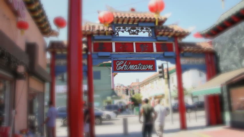 Macro shot of tourists leaving Chinatown sign