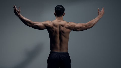 Fitness model back muscles and wingspan. Medium shot. 