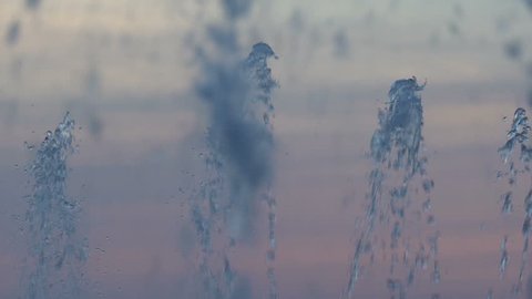 Spray of a fountain closeup on a sky background
