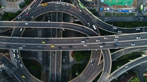 Aerial top down view on busy multilevel interchange overpass in Shanghai showing afternoon traffic coming from the elevated roads