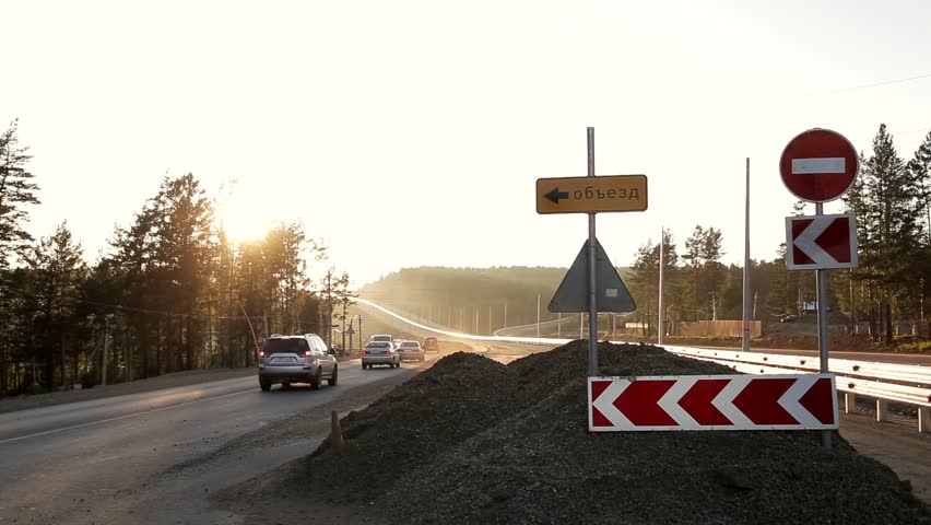Road signs at the under construction road in summer day
