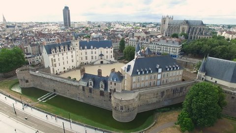 Aerial view of cityscape of Nantes, fort Chateau de Nantes, famous Cathedral of St. Peter and St. Paul in background - Normandy, France, 4k UHD  