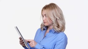 Young smiling woman thinking while using tablet isolated