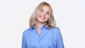 Confident blonde woman in blue shirt looking camera and smiling isolated