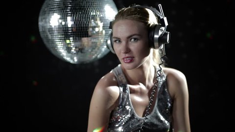 a sexy gogo dancer shot in a studio dancing and posing with a spinning discoball