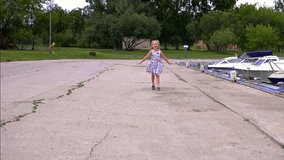 Slow-motion of a cheerful little cutie jumping happily little girl