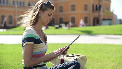 Female student with tablet computer on campus