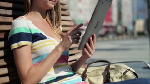 Young woman with tablet computer in the city
