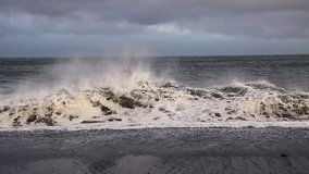 Stunning of Kirkjufjara beach and sunny waves. Picturesque and gorgeous scene. Location place Sudurland, cape Dyrholaey, Vik village, South Iceland, Europe. Beauty world. Shooting in HD 1080 video.