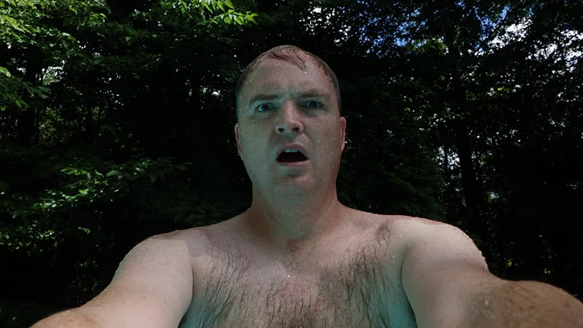 Man falling into swimming pool in slow motion. Man free falling into backyard pool in summer.