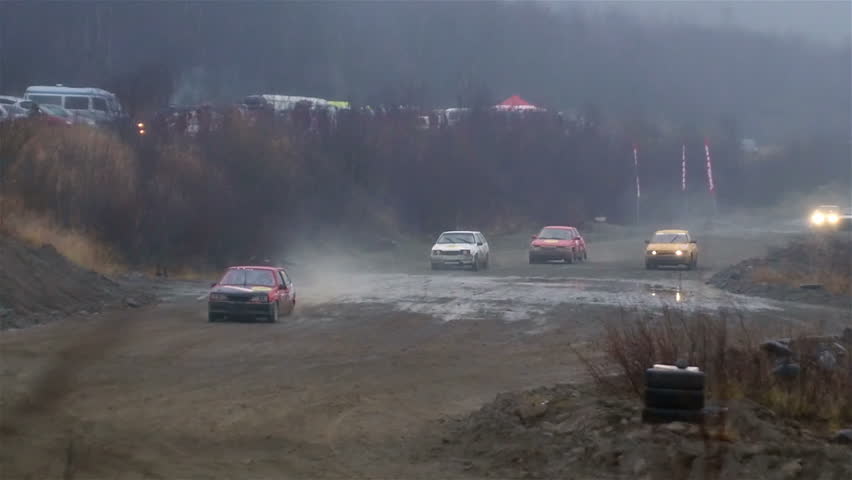 Off-road race, cars jumping along the road in slow motion.
