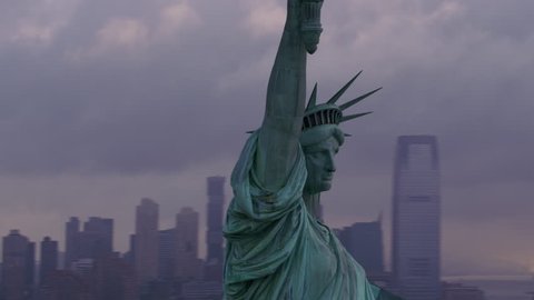 New York City circa-2017, Pull out from close-up of Statue of Liberty to reveal Manhattan and morning clouds. Shot with Cineflex and RED Epic-W Helium.