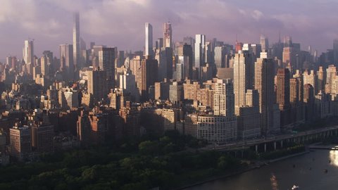 New York City circa-2017, Flying up Hudson River at sunrise with Manhattan buildings and piers. Shot with Cineflex and RED Epic-W Helium.