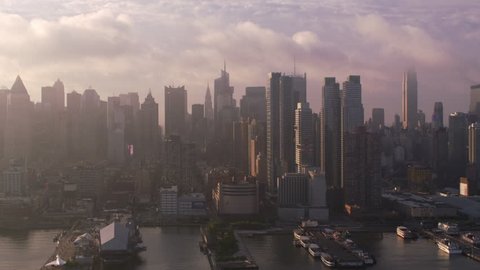 New York City circa-2017, Flying up Hudson River at sunrise with Manhattan buildings and piers. Shot with Cineflex and RED Epic-W Helium.