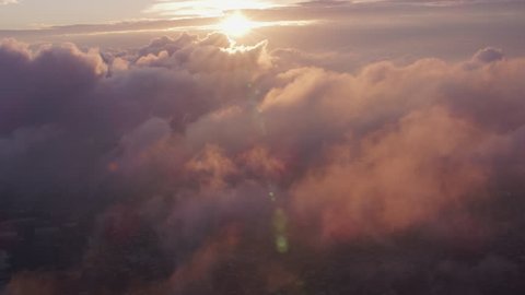 New York City circa-2017, Aerial view of sunrise over clouds with Manhattan below. Shot with Cineflex and RED Epic-W Helium.