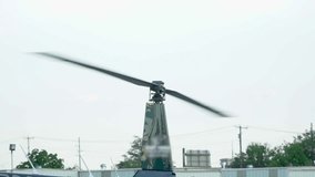Helicopter rotor blades spinning in slow motion on engine start up ready for takeoff to fly depart from airport