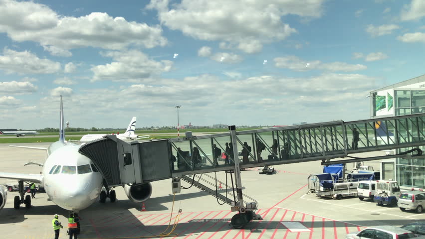 Boarding an airplane at the airport. Long shot