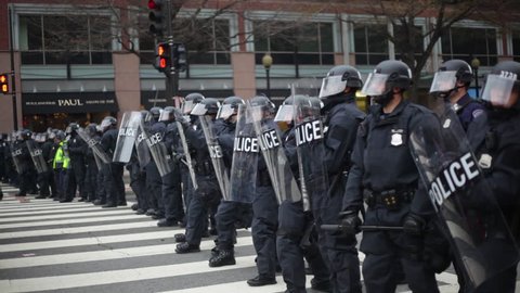 Washington D.C.-2010s: Police in riot gear form a line to confront protestors at Trump's Inauguration in Washington DC.