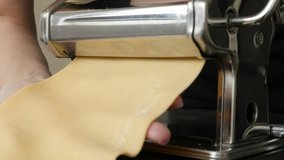 Close-up of manual processed lasagna sheets  4K 2160p 30fps UltraHD footage - Dough shaped in pasta machine 3840X2160 UHD video