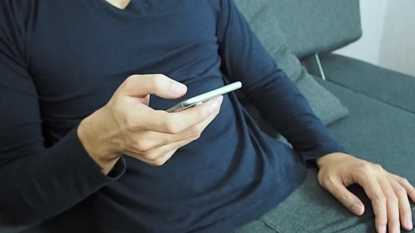 Using smart phone on sofa