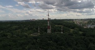 Ukraine. Kiev. July 2, 2017. Aerial photography. 4K video. Trees. Forest. Tower. Move the drone down, the camera is straight.