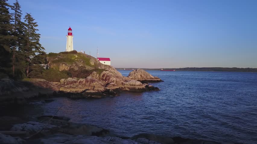 Aerial View of Lighthouse Park with Vancouver City in the Background. Taken in Horseshoe Bay, British Columbia, Canada, during sunset.