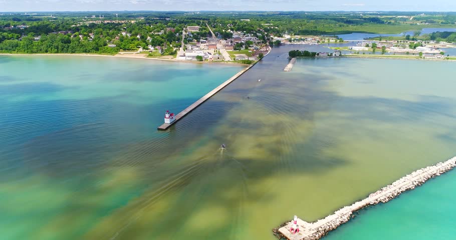 Splendid aerial view of sunlight and moving cloud shadows on Lake Michigan’s beautiful Kewaunee Wisconsin Harbor.