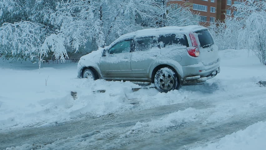 Car wheels riding on deep snow at winter season Royalty-Free Stock Footage #28518856